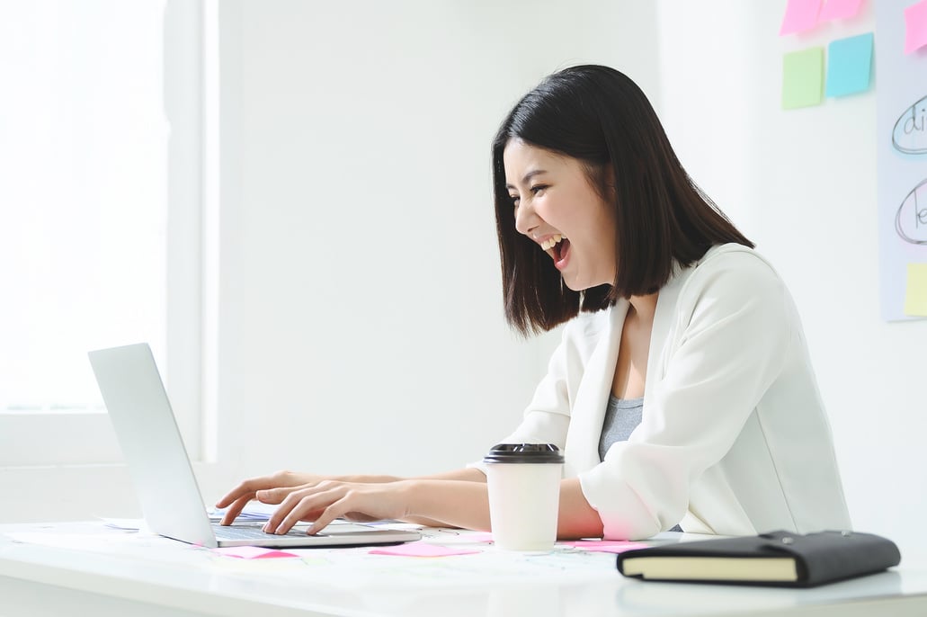 Young Businesswoman Feeling Happy Working on Laptop