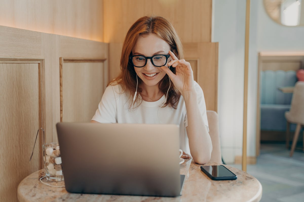 Woman Remote Worker Looks in Laptop Screen